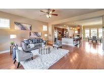 Spacious living room featuring hardwood floors, a cozy seating area, and an open floor plan at 8537 E 35Th Ave, Denver, CO 80238