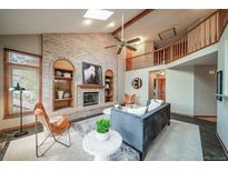 Spacious living room features a fireplace and vaulted ceiling at 9546 Cherryvale Dr, Highlands Ranch, CO 80126