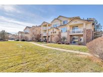 Two-story building with balconies and lawn at 5726 N Genoa Way # 10-106, Aurora, CO 80019