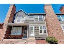 Brick and gray siding townhouse exterior with landscaping at 16941 E Chenango Ave # C, Aurora, CO 80015