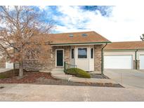 Brick front exterior of charming ranch-style home with attached garage at 2617 E Egbert St, Brighton, CO 80601