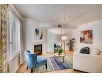 Bright living room with fireplace, comfy seating, and large windows at 1330 S Monaco Pkwy # 2, Denver, CO 80224