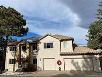 Two-story house with a three-car garage and solar panels, nicely landscaped at 22141 Chippewa, Golden, CO 80401