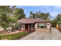 House exterior showcasing a charming ranch home with a landscaped yard at 1219 Tucson St, Aurora, CO 80011