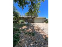 Ranch-style home with a single car garage and landscaping at 12831 E Mexico Ave, Aurora, CO 80012