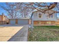 Brick ranch home with attached three-car garage and landscaped yard at 8160 W 81St Pl, Arvada, CO 80005