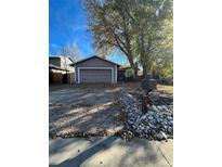 Ranch style home with attached garage and mature tree in front yard at 3658 S Norfolk Way, Aurora, CO 80013