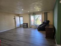 Spacious living room with hardwood floors and lots of natural light at 11507 Monroe Way, Thornton, CO 80233