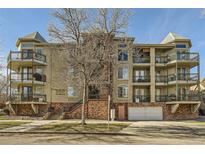 Three-story building exterior with balconies and a tree in front at 1705 Gaylord St # 107, Denver, CO 80206