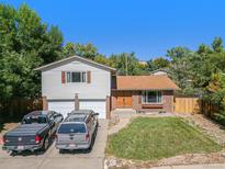 Two-story house with attached two-car garage and front yard at 17215 W 15Th Pl, Golden, CO 80401