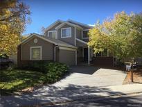 Two-story house with a charming facade and landscaped yard at 13674 Plaster Cir, Broomfield, CO 80023