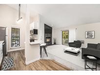 Open living room and kitchen with fireplace and balcony access at 2800 Kalmia Ave # C314, Boulder, CO 80301