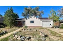 Ranch style home with garden and detached garage at 6027 W 61St Pl, Arvada, CO 80003