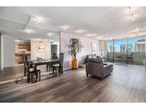 Spacious living room with hardwood floors, city view, and ample natural light at 1020 15Th St # 28H, Denver, CO 80202