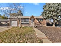 Brick ranch house with attached garage at 1241 Coring Pl, Northglenn, CO 80233