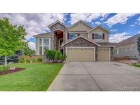 Two-story house with stone accents and a three-car garage at 4864 Harness Ct, Parker, CO 80134