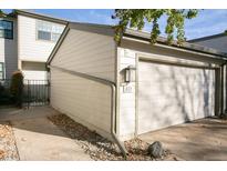 View of the property's garage, with a spacious single car garage and additional parking at 7900 W Layton Ave # 833, Littleton, CO 80123
