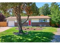 Ranch-style home with red door, attached garage, and landscaped yard at 384 Diane Ct, Lone Tree, CO 80124