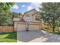 Two-story house with a three-car garage and basketball hoop at 18872 E Prentice Pl, Centennial, CO 80015