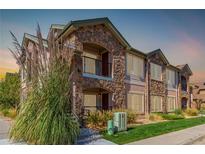 Two-story townhome with stone accents and landscaped grounds at 15195 E 16Th Pl # 204, Aurora, CO 80011