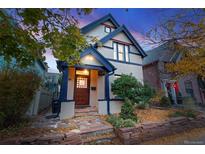 Beautiful two-story home with a welcoming porch and landscaping at 408 E 1St Ave, Denver, CO 80203