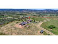 Aerial view of property showcasing home, expansive land, and mountain views at 934 S Perry Park Rd, Sedalia, CO 80135