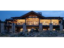 Luxury home exterior at dusk, stone facade, large windows at 7474 Spring Drive, Boulder, CO 80303