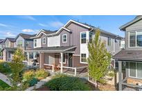 Two-story townhome with front porch and landscaping at 8835 Meade St, Westminster, CO 80031