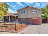 Ranch-style home with brick facade, attached garage and landscaping at 10828 Roseanna Dr, Northglenn, CO 80234