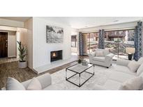 Living room features a fireplace and access to a patio at 500 Manhattan Dr # B1, Boulder, CO 80303