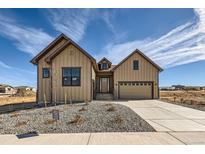 Modern farmhouse style home with tan siding at 5134 Cupule Trl, Castle Rock, CO 80104