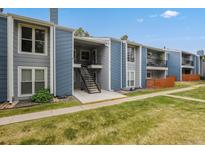 Exterior of a light blue condominium building with stairs and balconies at 2215 E Geddes Ave # P08, Littleton, CO 80122