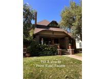 Brick house with a classic design, landscaped yard, and inviting front porch at 757 S Vine St, Denver, CO 80209