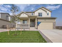 Two story house with light beige siding and a large front yard at 5721 Wayfarer Cir, Firestone, CO 80504