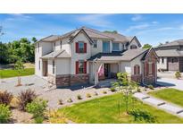 Two-story home with stone accents and red shutters at 15 Latigo Pl, Littleton, CO 80123