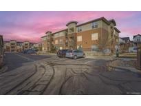 Apartment building with parking lot and surrounding buildings at 4100 Albion St # 512, Denver, CO 80216