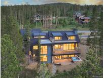 Luxury home with mountain views, deck, and hot tub; multiple levels and large windows at 245 Fairways Dr, Breckenridge, CO 80424