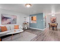 Bright living room with light walls and hardwood floors at 1260 York St # 105, Denver, CO 80206