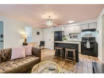 Open kitchen with granite countertops and modern appliances at 1355 Gaylord St # 10, Denver, CO 80206