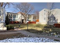 Exterior view of a townhome community with green space at 1050 S Monaco Pkwy # 88, Denver, CO 80224