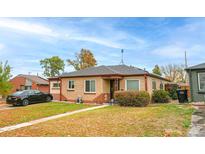 Brick ranch home with a well-manicured lawn at 2862 N Monroe St, Denver, CO 80205