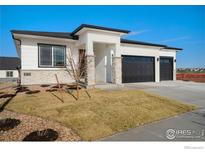 Modern two-story house with a three-car garage at 23845 E River Front Dr, Aurora, CO 80019