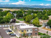 Aerial view of a multi-Gathering building, with mountain views in the background at 270 S Cherrywood Dr # 103, Lafayette, CO 80026