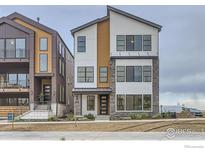 Modern two-story townhome with stone and wood accents at 1765 Peak Loop, Broomfield, CO 80023