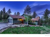 Rustic two-story home nestled in the woods; perfect for mountain living at 124 Deer Trail Cir, Boulder, CO 80302