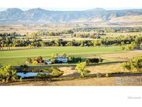 Aerial view of a house and expansive property with mountain views at 7484 N 49Th St, Longmont, CO 80503