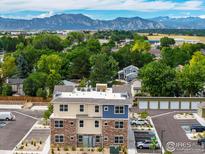 Aerial view of a two-story building with mountain backdrop at 290 S Cherrywood Dr # 102, Lafayette, CO 80026