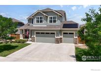 Two-story house with three-car garage and landscaped yard at 868 Ranchhand Dr, Berthoud, CO 80513