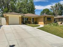 Ranch style home with a spacious driveway and landscaped yard at 161 Emerald St, Broomfield, CO 80020