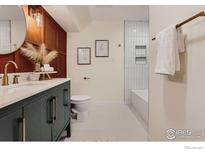 Modern bathroom with stylish vanity, bathtub, and tile at 7615 E Quincy Ave # 102, Denver, CO 80237